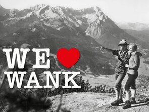 A couple enjoys the view of Wank in the Alps.