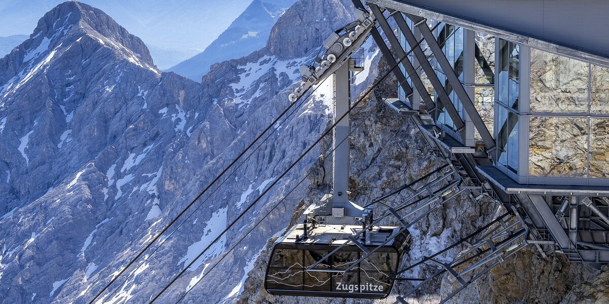 Aerial view of the Zugspitze cable car station and mountains.