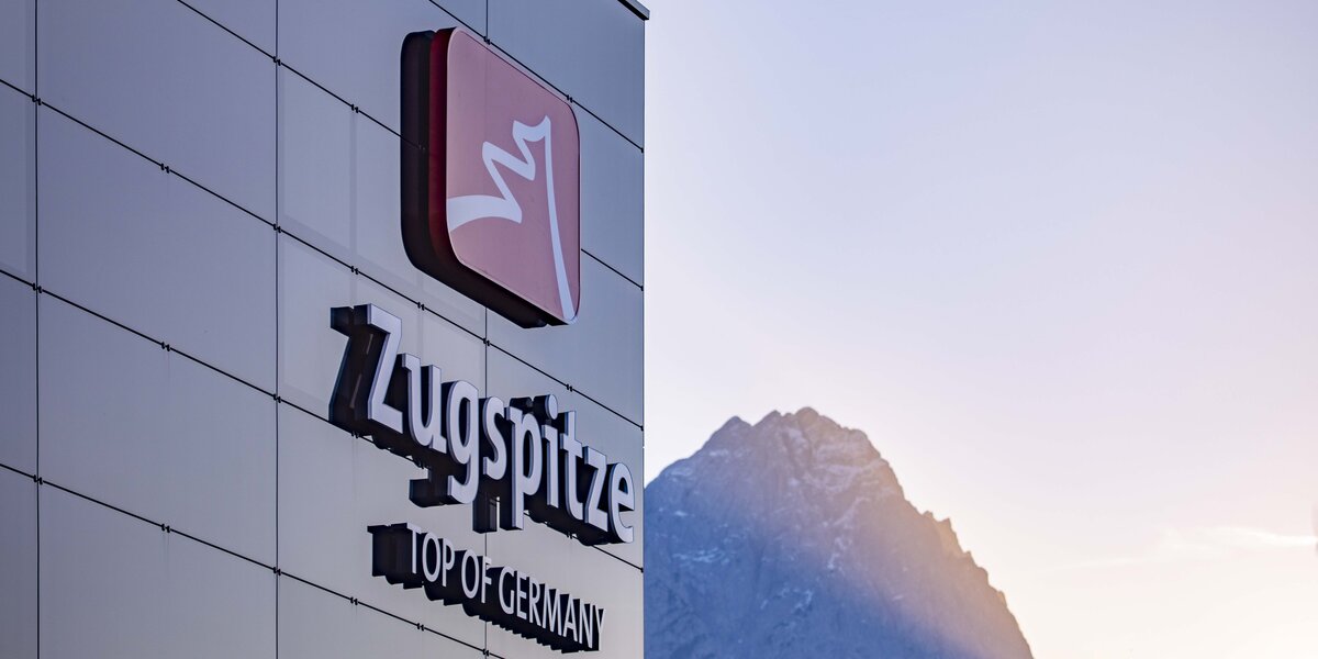 Das Logo der Zugspitze mit dem Berg im Hintergrund.