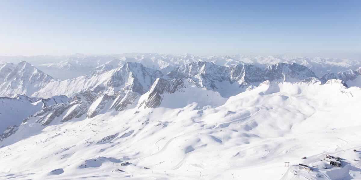 Snow-covered mountain landscape with clear sky.